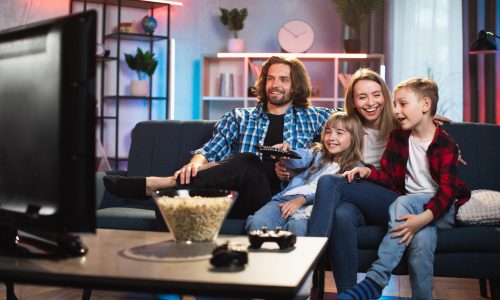 happy-family-watching-tv-at-home-2024-12-10-04-04-41-utc-min